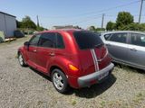 a red car parked next to a silver car in a parking lot