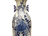 a blue and white vase sitting on a white surface