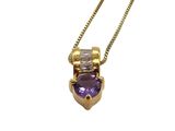 a close up of a necklace with a purple stone on a chain