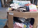 a box full of clothes sitting on top of a pile of boxes