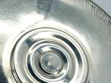 a silver plate with a circular design on it