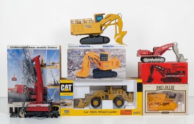 a lot of toy construction vehicles on display on the table