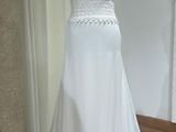 wedding dress on a mannequin display in a bridal shop