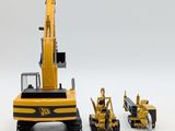 three toy construction vehicles that are sitting next to each other