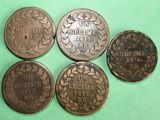 four different types of coins are shown on a green surface