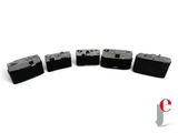 four batteries that are lined up on a white surface