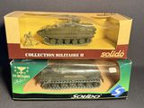 two boxed boxed military toys of a tank and a soldier figure