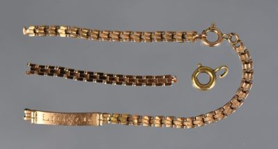 a close up of a gold bracelet and a chain with a clasp