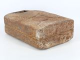 a stone box that is sitting on a white surface