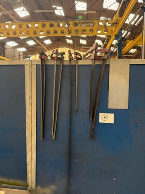 a blue wall with a bunch of tools hanging on it