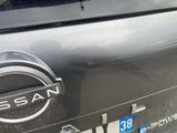 a close up of a nissan emblem on the back of a car