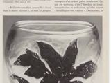 an old black and white photo of a glass vase with flowers in it