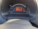 a car dashboard with a speedometer and a clock on it