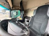 a view of the inside of a truck from the driver ' s seat