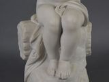 marble statue of a young boy sitting on a rock holding a flower