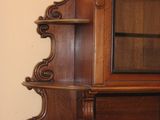 a wooden cabinet with a mirror on top of it