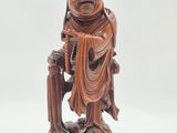 an image of a wooden statue of a man with a hat on his head
