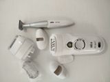a white electric shaver sitting on a table next to other items