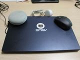 a laptop computer sitting on top of a wooden desk