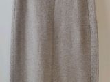 the skirt is made of wool and has a zipper at the waist