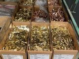 many boxes of gold and silver coins on a table