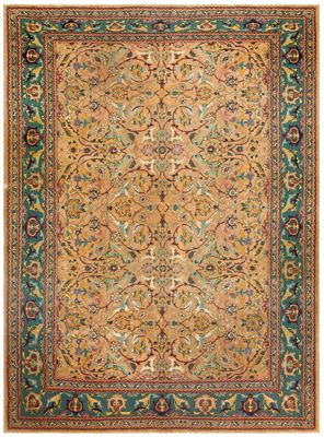 an antique persian rug with a floral design on a green ground