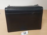 a black purse sitting on top of a wooden table