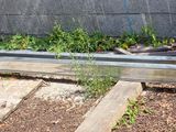 a pile of wood sitting next to a concrete wall