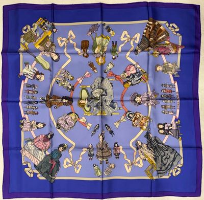 a blue square scarf with a picture of a group of people on it