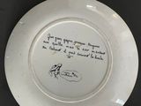 a white plate with writing on it on a table