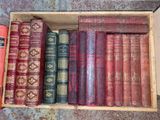 many old books in a wooden box on the floor