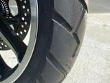 a close up of a motorcycle tire on a concrete surface