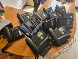 a lot of telephones on the table in the office