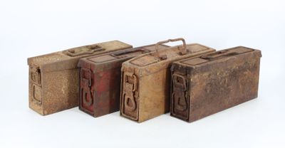 three old suitcases are lined up in a row on a white surface
