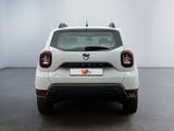 the rear end of a white car in a white room