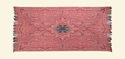 an old red rug with a floral design and fringes on it