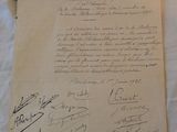 an old document with a lot of writing on it sitting on a table