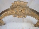 a wooden chair with a flower decoration on the back