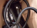 a box with a hose and a phone inside of it