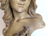 a statue of a woman with a hat on her head