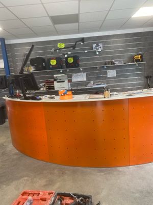 a large orange counter in a garage with tools on the counter