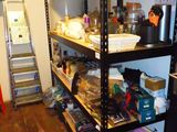 a shelf that has many items on it in the room