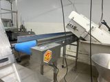a picture of a machine in a factory with a conveyor belt