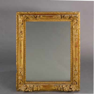an image of a gold framed mirror sitting on top of a table