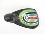 a small black object with a green and red design on it