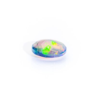 a white oplite stone with a green and purple color