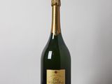 a bottle of champagne sitting on top of a wooden table