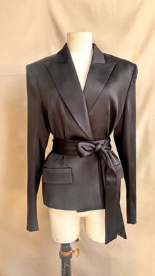 the jacket is black and has a tie around the waist