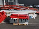 a lot of red and gray metal items in a parking lot