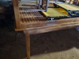 a wooden table with a yellow table cloth on it